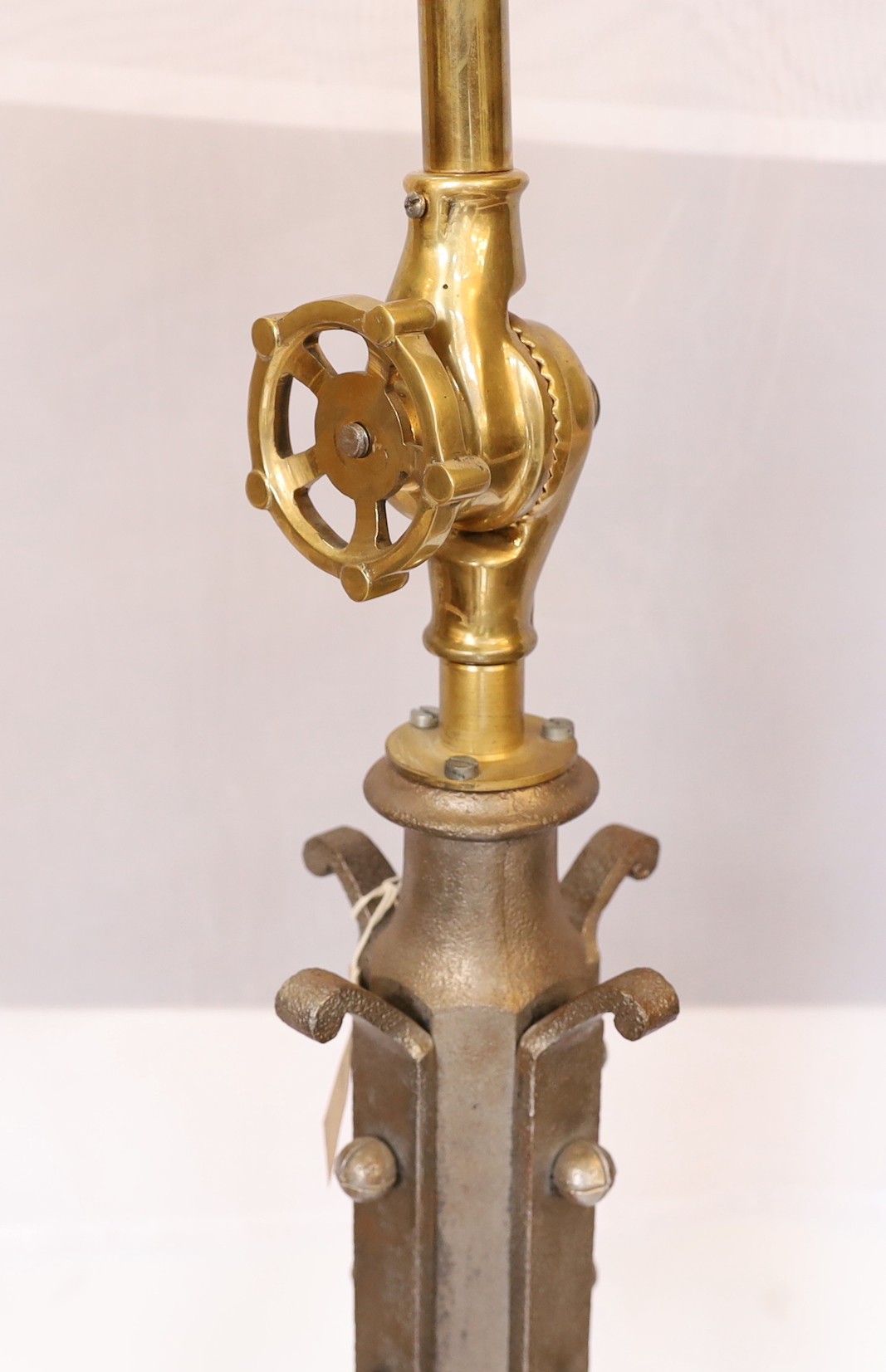 A pair of industrial style brass and wrought iron adjustable lamp standards, height 194cm. width of base 62cm